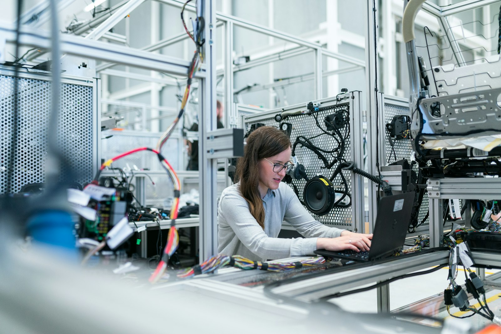 Engineer working at a laptop in an industrial setting